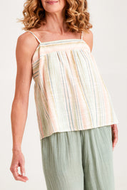 Model Emma wearing the Cotton Stripe Cami in colour Softstripe (Green), from the front, cropped image