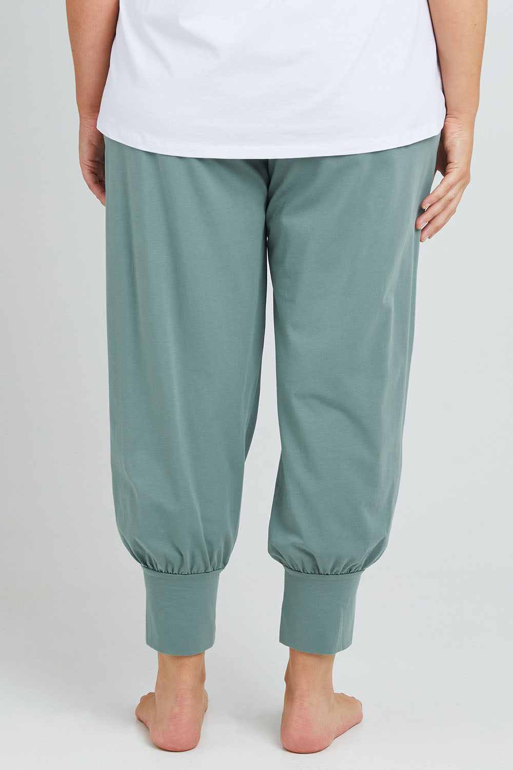 Model Poppy wearing the Cotton Jersey Pull On Jogger in colour Sage (Green), from the back
