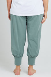 Model Poppy wearing the Cotton Jersey Pull On Jogger in colour Sage (Green), from the back