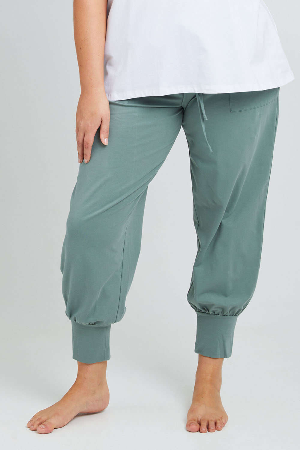 Model Poppy wearing the Cotton Jersey Pull On Jogger in colour Sage (Green), from the front, cropped image