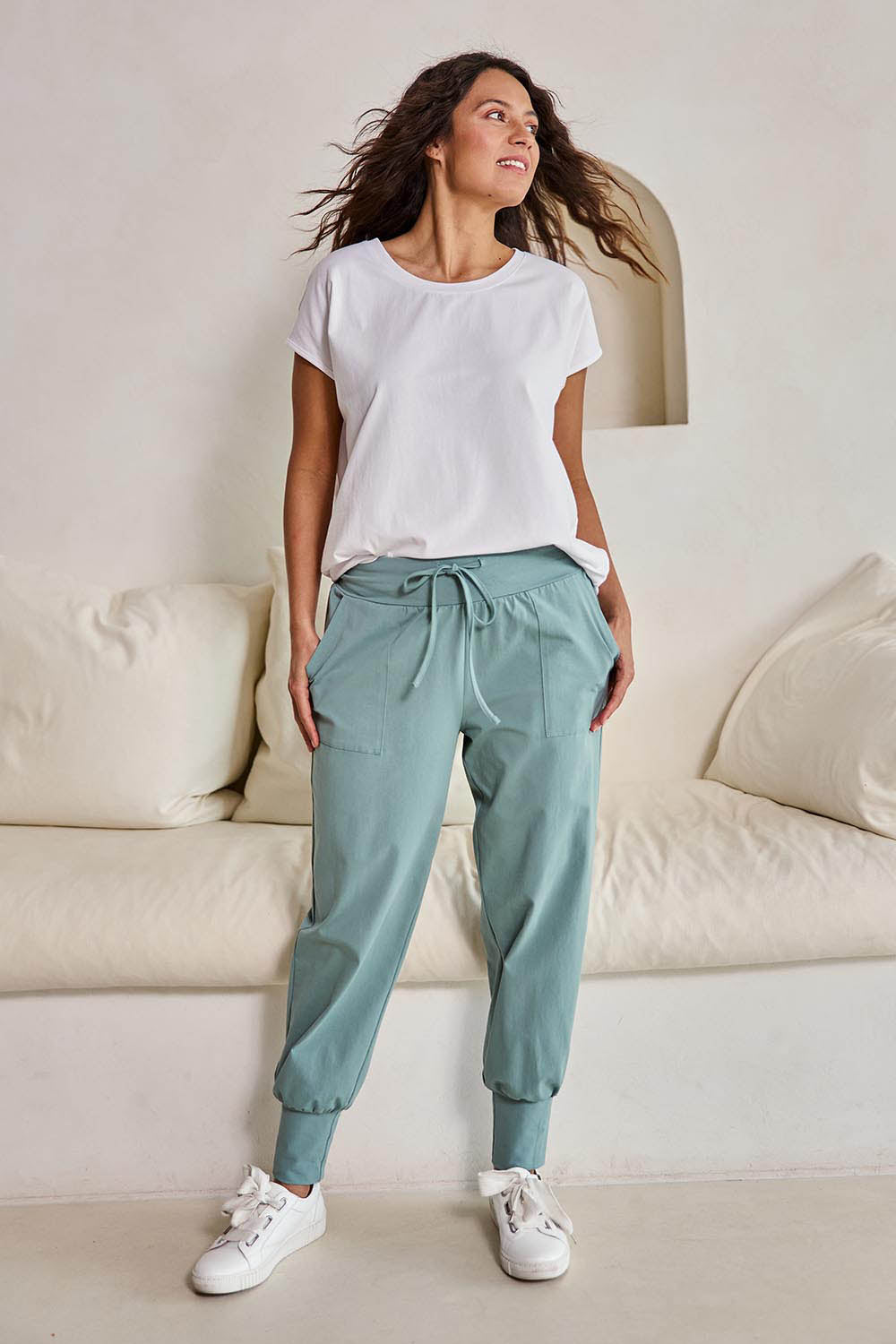Model Tahneei wearing size 10 of the Cotton Jersey Pull On Jogger – Sage in colour Sage, from the front