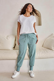 Model Tahneei wearing size 10 of the Cotton Jersey Pull On Jogger – Sage in colour Sage, from the front