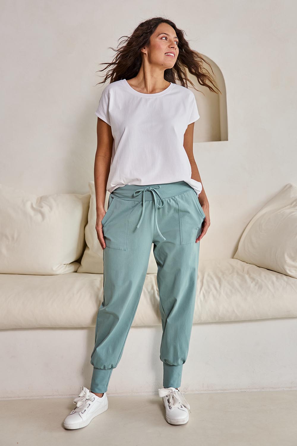 Model Tahneei wearing size 10 of the Cotton Jersey Pull On Jogger – Sage in colour Sage, from the front