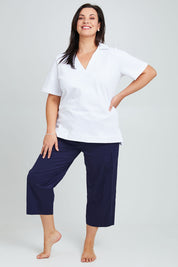 Model Poppy wearing the Cotton Terry Collared Tee in colour White (White), from the front, showing the whole outfit