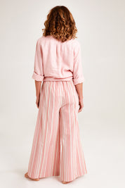 Model Emma wearing the Cotton Pull On Lounge Pants in colour Pinkstripe (Pink), from the back