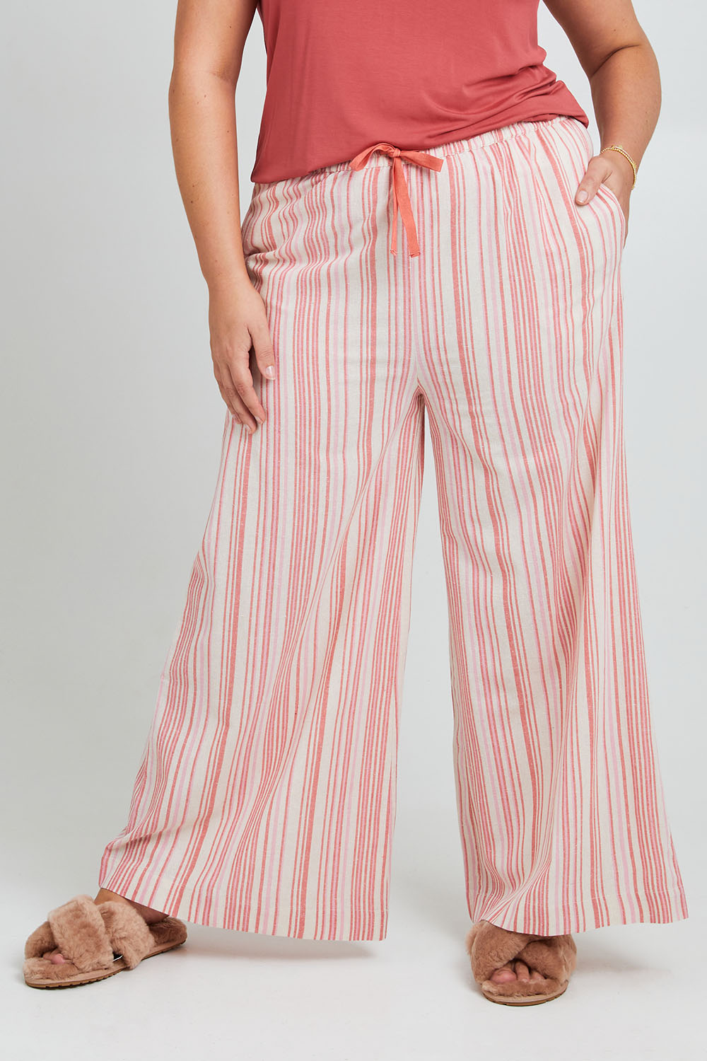 Model Poppy wearing the Cotton Pull On Lounge Pants in colour Pinkstripe (Pink), from the front, cropped image