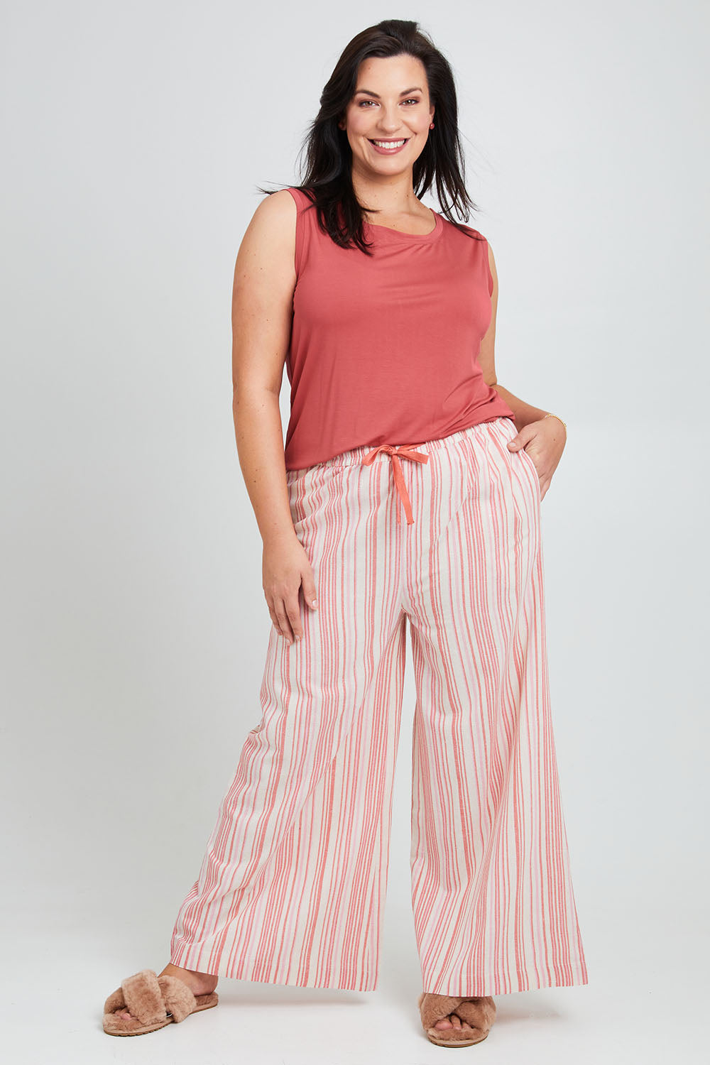 Model Poppy wearing the Cotton Pull On Lounge Pants in colour Pinkstripe (Pink), from the front, showing the whole outfit