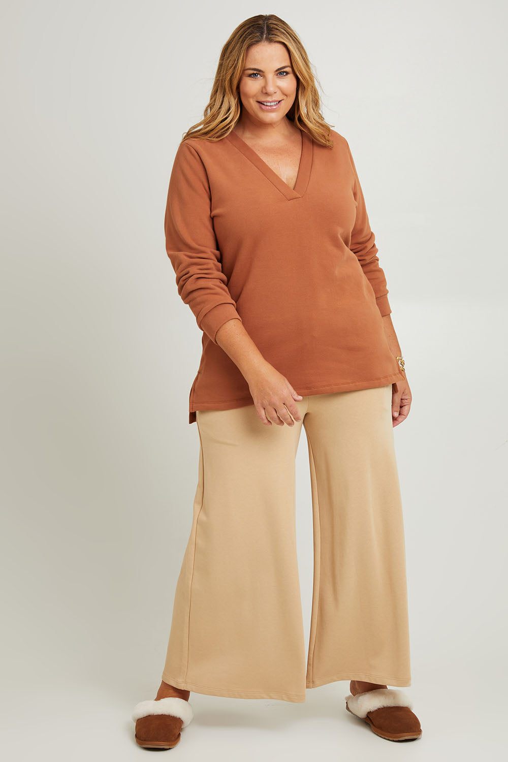 Model Fiona wearing the Cotton Fleece V Neck Sweater in colour Toffee, from the front, showing the whole outfit