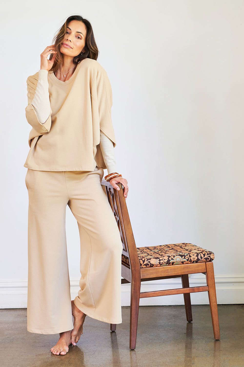 Model Amanda wearing the Cotton Terry Wide Leg Track Pants in colour Porridge, from the front, showing the whole outfit