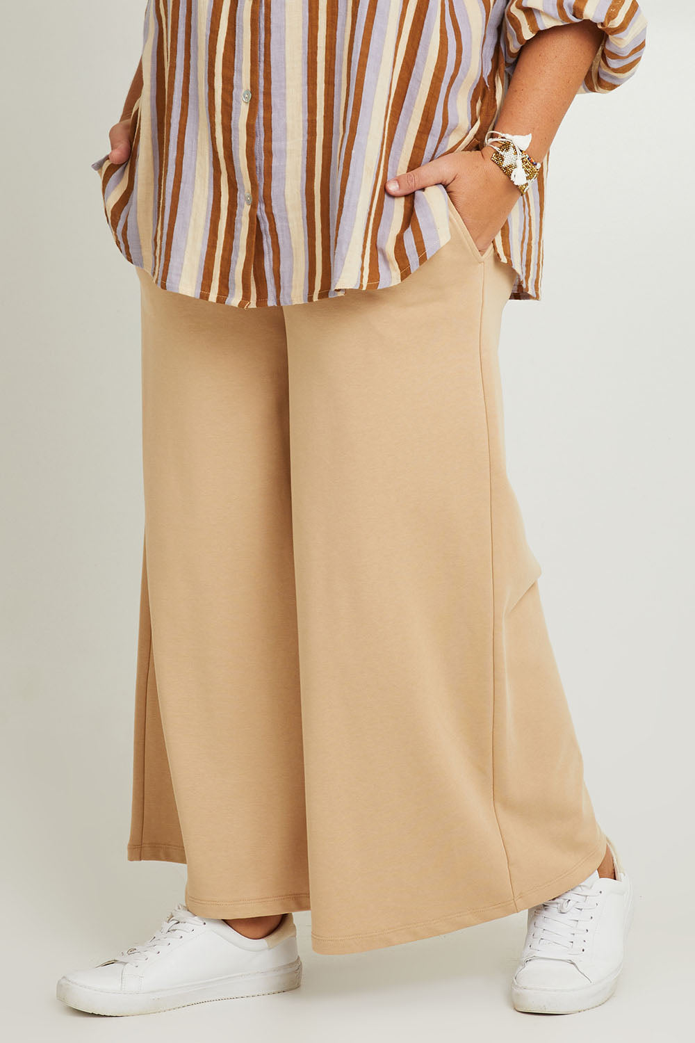 Model Fiona wearing the Cotton Terry Wide Leg Track Pants in colour Porridge, from the front, cropped image