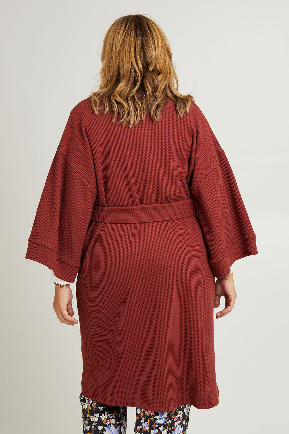 Model Fiona wearing the Cotton Waffle Dressing Robe in colour Rhubarb (Red), from the back