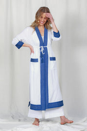 Model Olivia wearing the Cotton Dressing Gown in colour Santorini (Blue), from the front, showing the whole outfit