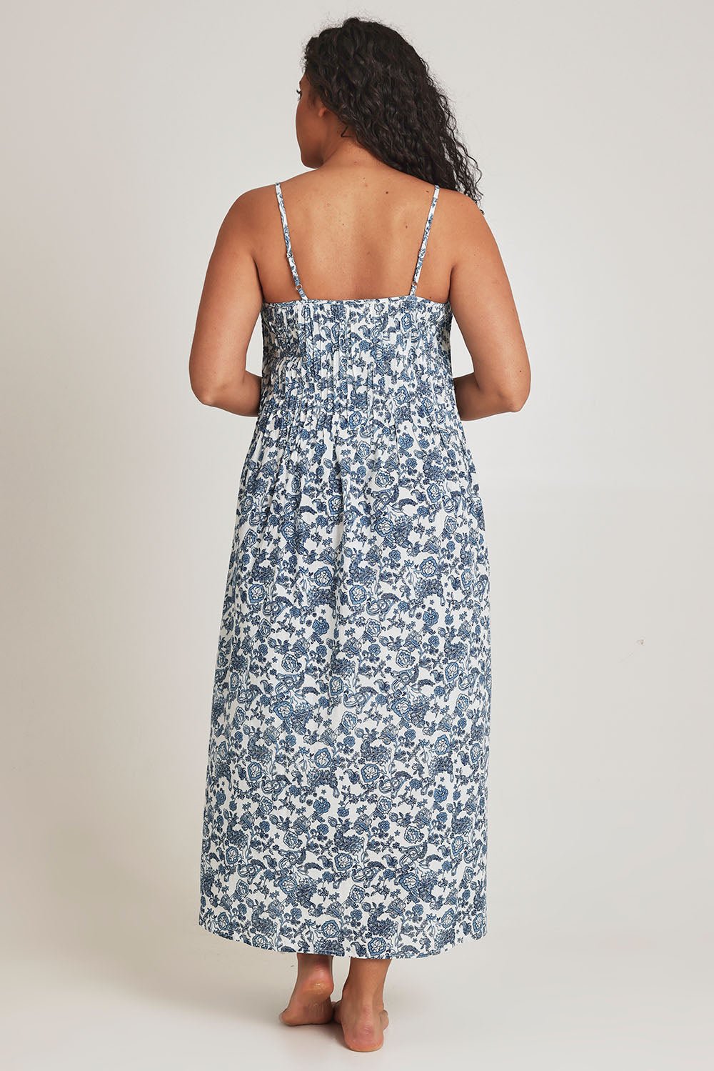 Model Terri-Leigh wearing the Cotton Pintucked Slip in colour Paisley (Blue), from the back