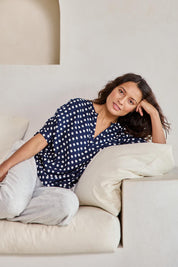 Model Tahneei wearing size 10 of the Viscose Twill Pyjama Top – Navyspot in colour Navyspot, in a cropped view