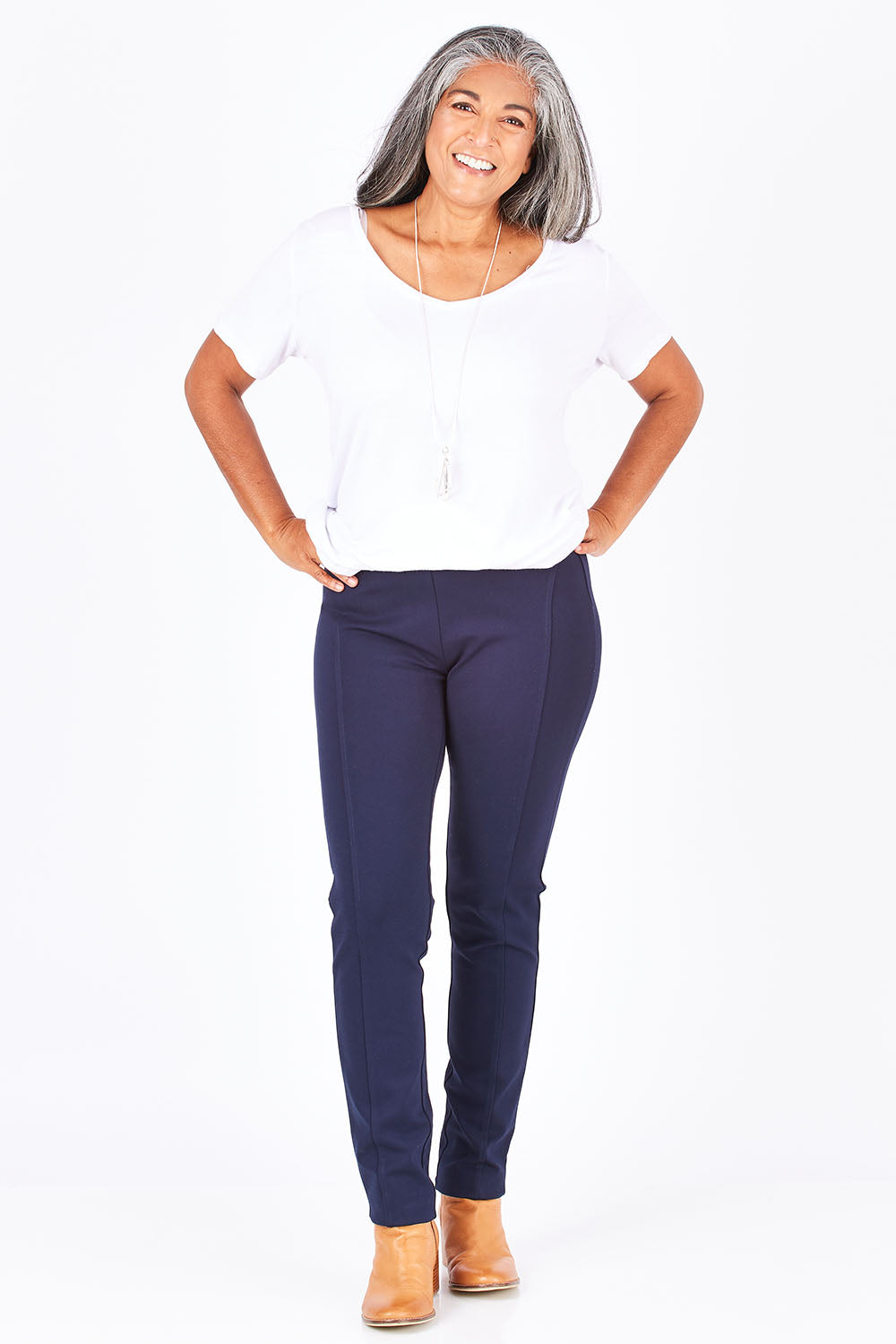 Model Nadine wearing size 10 of the Ponti Skinny Leg Pull On Pant in colour Navy (Blue), from the front, showing the whole outfit