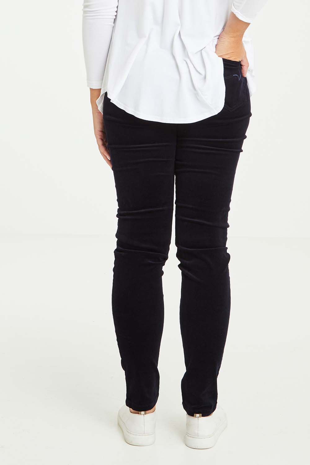 Model Tahlia wearing size 10 of the Skinny Leg Cord Pull On Pant in colour Midnight (Blue), from the back