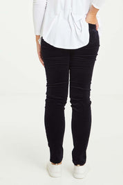 Model Tahlia wearing size 10 of the Skinny Leg Cord Pull On Pant in colour Midnight (Blue), from the back