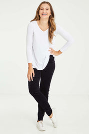Model Tahlia wearing size 10 of the Skinny Leg Cord Pull On Pant in colour Midnight (Blue), from the front, showing the whole outfit