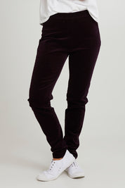 Model Katie wearing size 10 of the Skinny Leg Cord Pull On Pant in colour Mulberry (Purple), from the front, cropped image