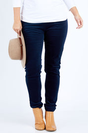 Model Jess wearing size 14 of the Skinny Leg Cord Pull On Pant in colour Navy (Blue), from the front, cropped image