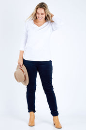 Model Jess wearing size 14 of the Skinny Leg Cord Pull On Pant in colour Navy (Blue), from the front, showing the whole outfit