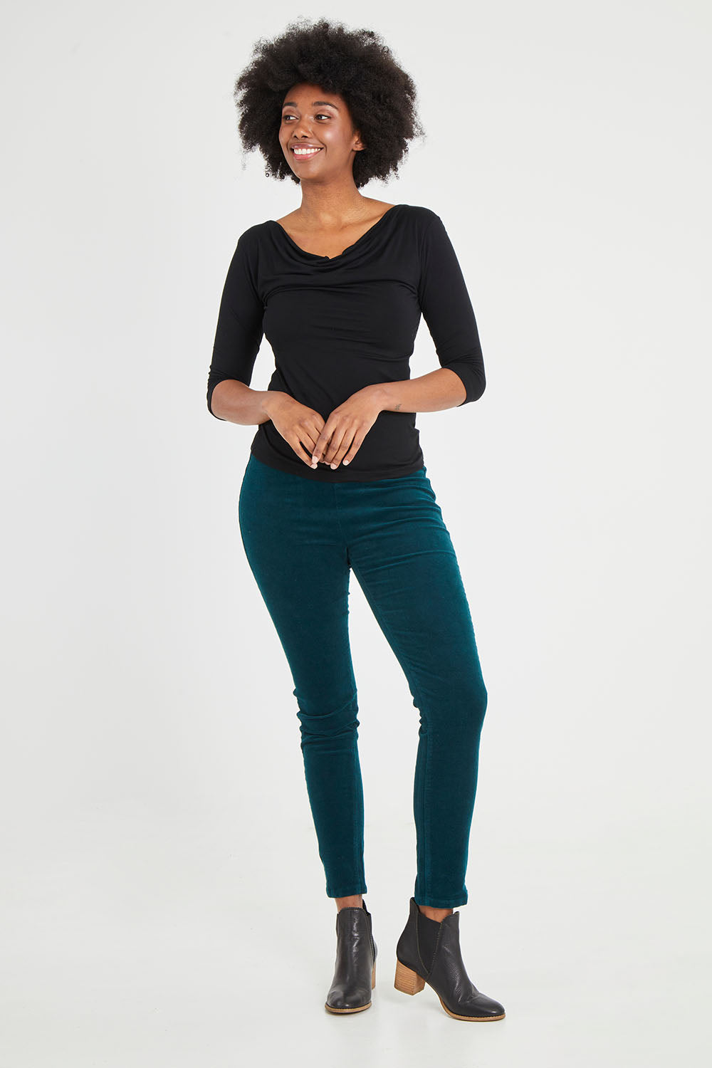 Model Aiyana wearing size 10 of the Skinny Leg Cord Pull On Pant in colour Peacock (Green), from the front, showing the whole outfit