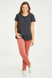 Model Tahlia wearing size 10 of the Skinny Leg Cord Pull On Pant in colour Rose (Pink), from the front, showing the whole outfit