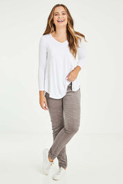 Model Tahlia wearing size 10 of the Skinny Leg Cord Pull On Pant in colour Taupe, from the front, showing the whole outfit