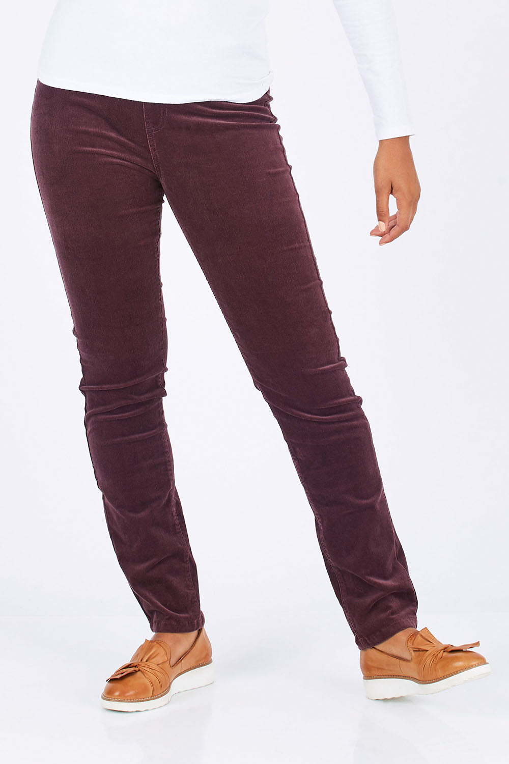 Model Summer wearing size 10 of the Skinny Leg Cord Pull On Pant in colour Vino (Purple), from the front, cropped image