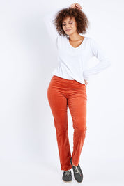 Model Lala wearing the Pin Cord Slim Pant in colour Auburn, from the front, showing the whole outfit