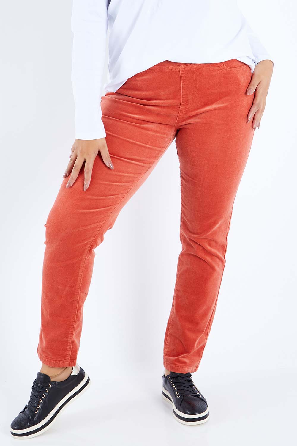 Model Sasha-Lee wearing size 16 of the Pin Cord Slim Pant in colour Auburn, from the front, cropped image