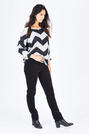 Model Gemma wearing size 10 of the Pin Cord Slim Pant in colour Black (Black), from the front, showing the whole outfit