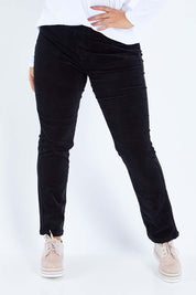 Model Sasha-Lee wearing size 16 of the Pin Cord Slim Pant in colour Black (Black), from the front, cropped image