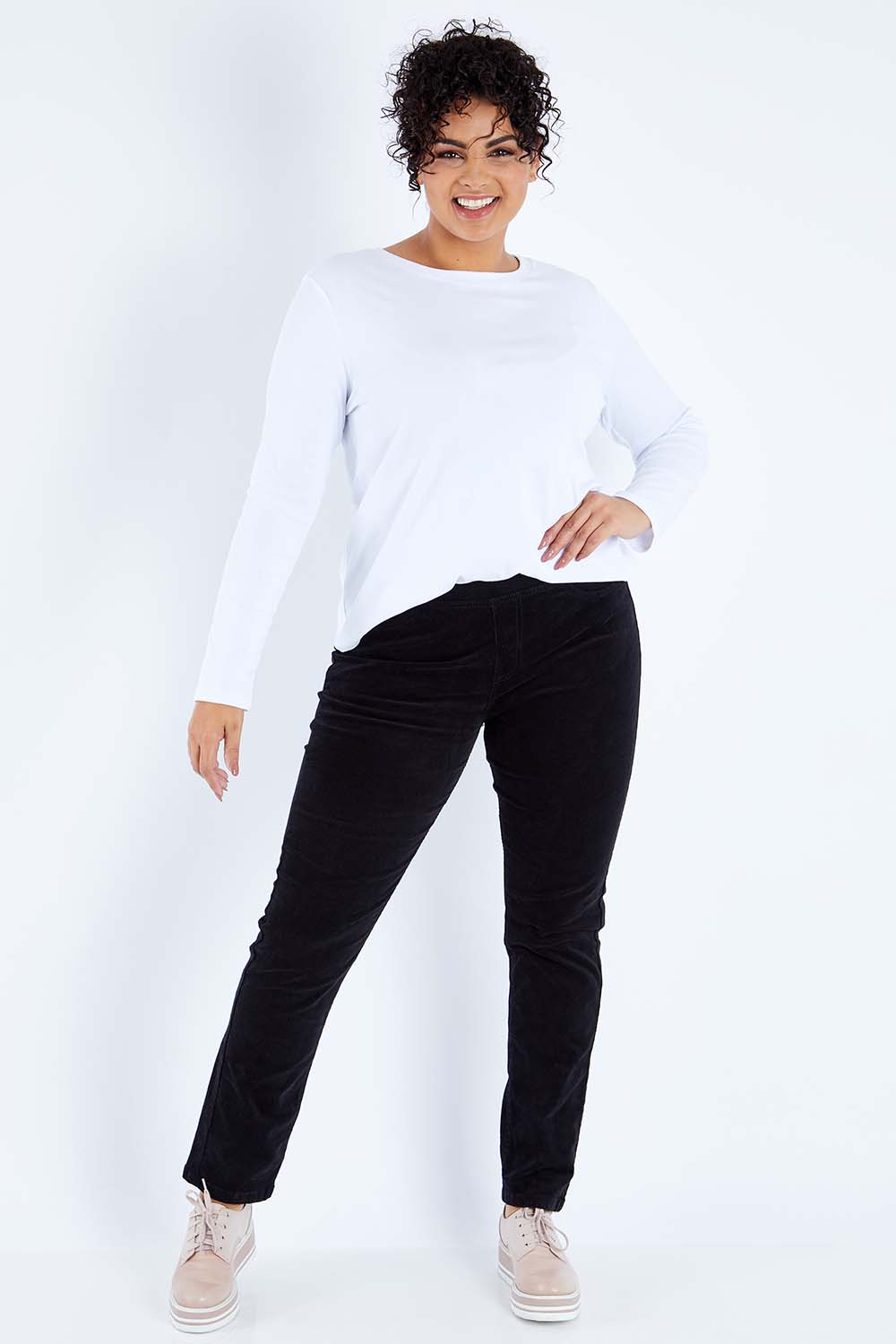 Model Sasha-Lee wearing size 16 of the Pin Cord Slim Pant in colour Black (Black), from the front, showing the whole outfit