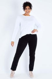 Model Sasha-Lee wearing size 16 of the Pin Cord Slim Pant in colour Black (Black), from the front, showing the whole outfit