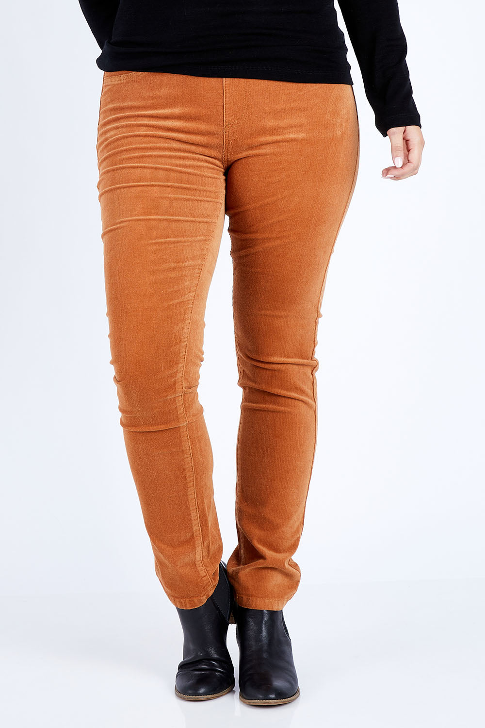 Model Jess wearing size 14 of the Pin Cord Slim Pant in colour Copper, from the front, cropped image