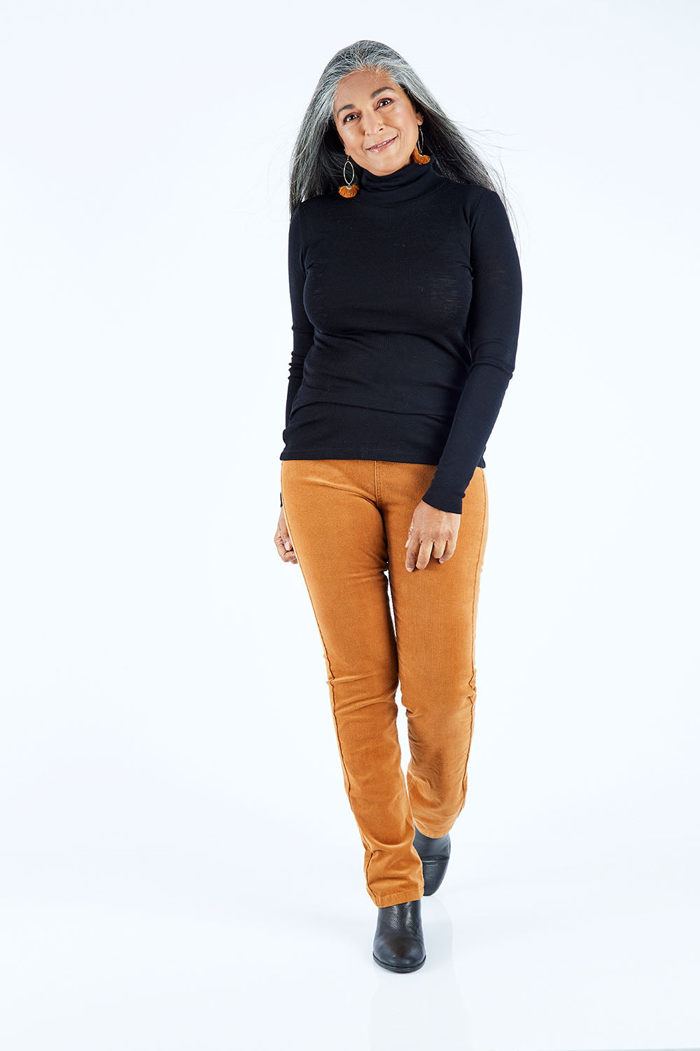Model Nadine wearing size 10 of the Pin Cord Slim Pant in colour Copper, from the front, showing the whole outfit