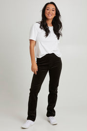 Model Katie wearing size 10 of the Pin Cord Slim Pant in colour Olive (Green), from the front, showing the whole outfit