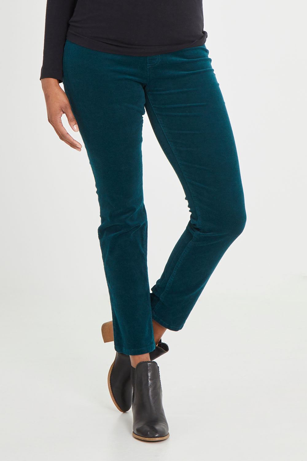 Model Aiyana wearing size 10 of the Pin Cord Slim Pant in colour Peacock (Green), from the front, cropped image