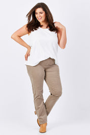 Model Mae wearing size 16 of the Pin Cord Slim Pant in colour Stone, from the front, showing the whole outfit