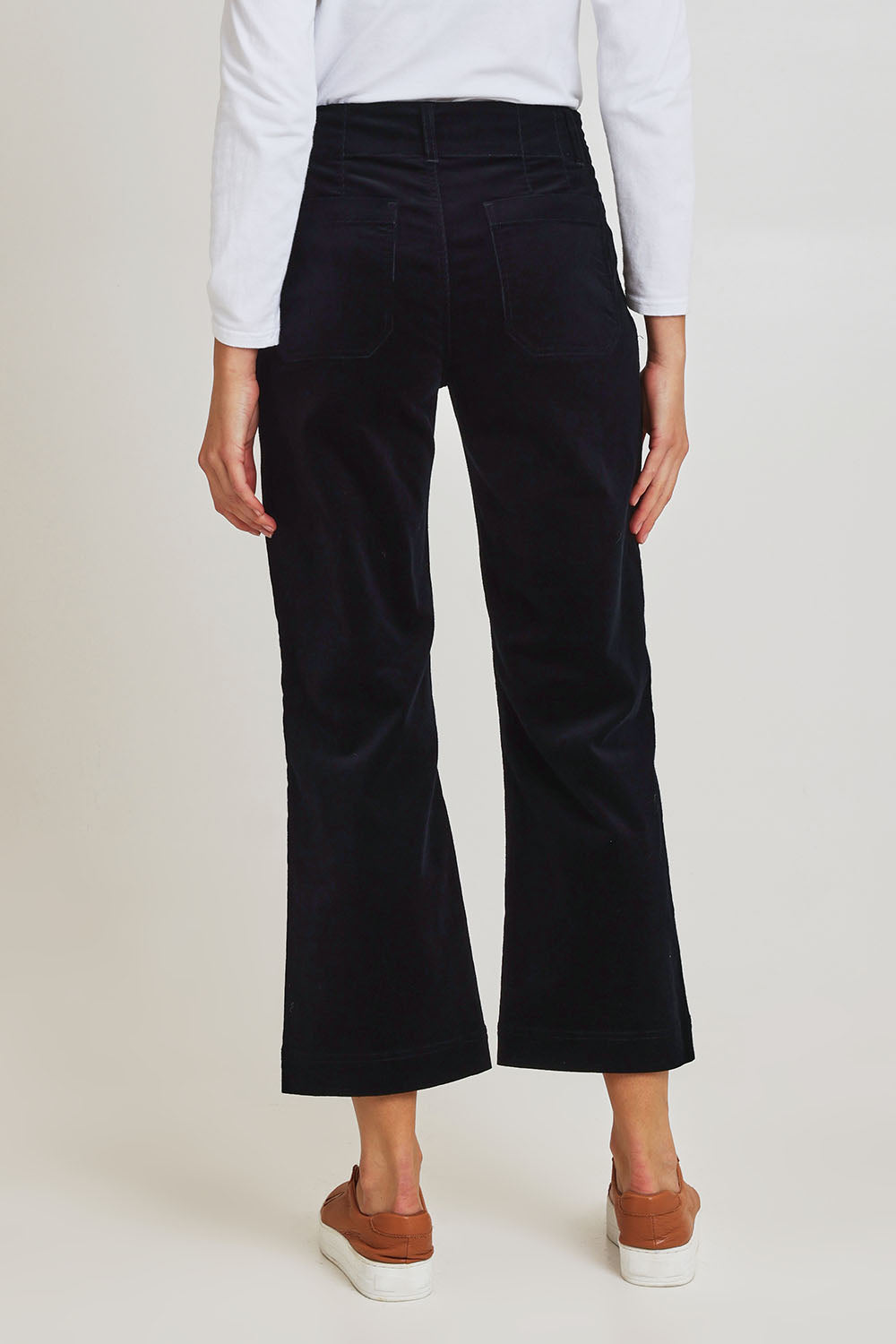 Model Madeline wearing size 10 of the Wide Leg Ankle Grazer Pant in colour Midnight (Blue), from the back