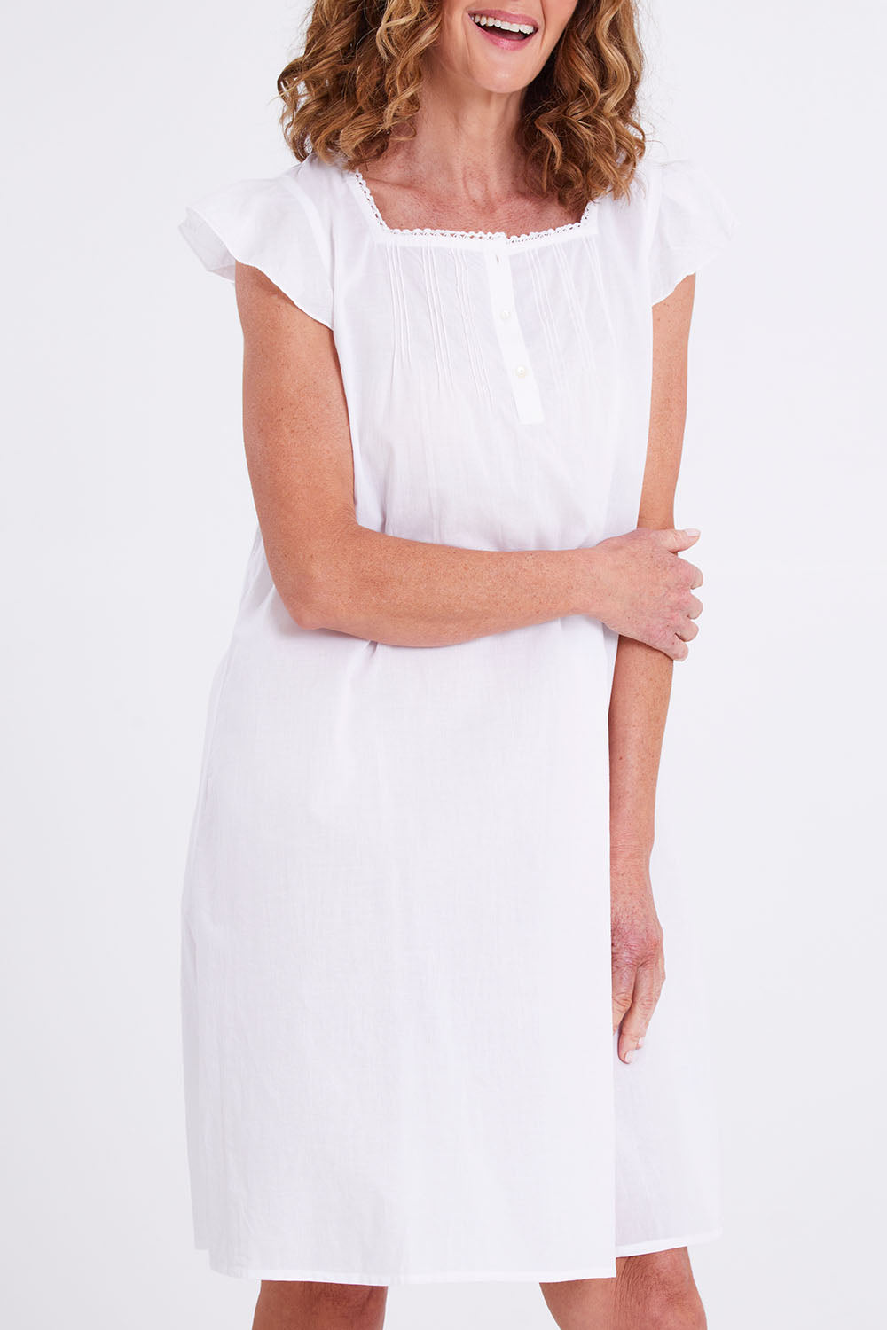 Model Emma wearing size S of the Riko Cotton Cap Sleeve Nightie in colour White (White), from the front, cropped image