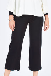 Model Chelsea wearing size S of the Wide Leg Ponte Pant in colour Black (Black), from the front, cropped image