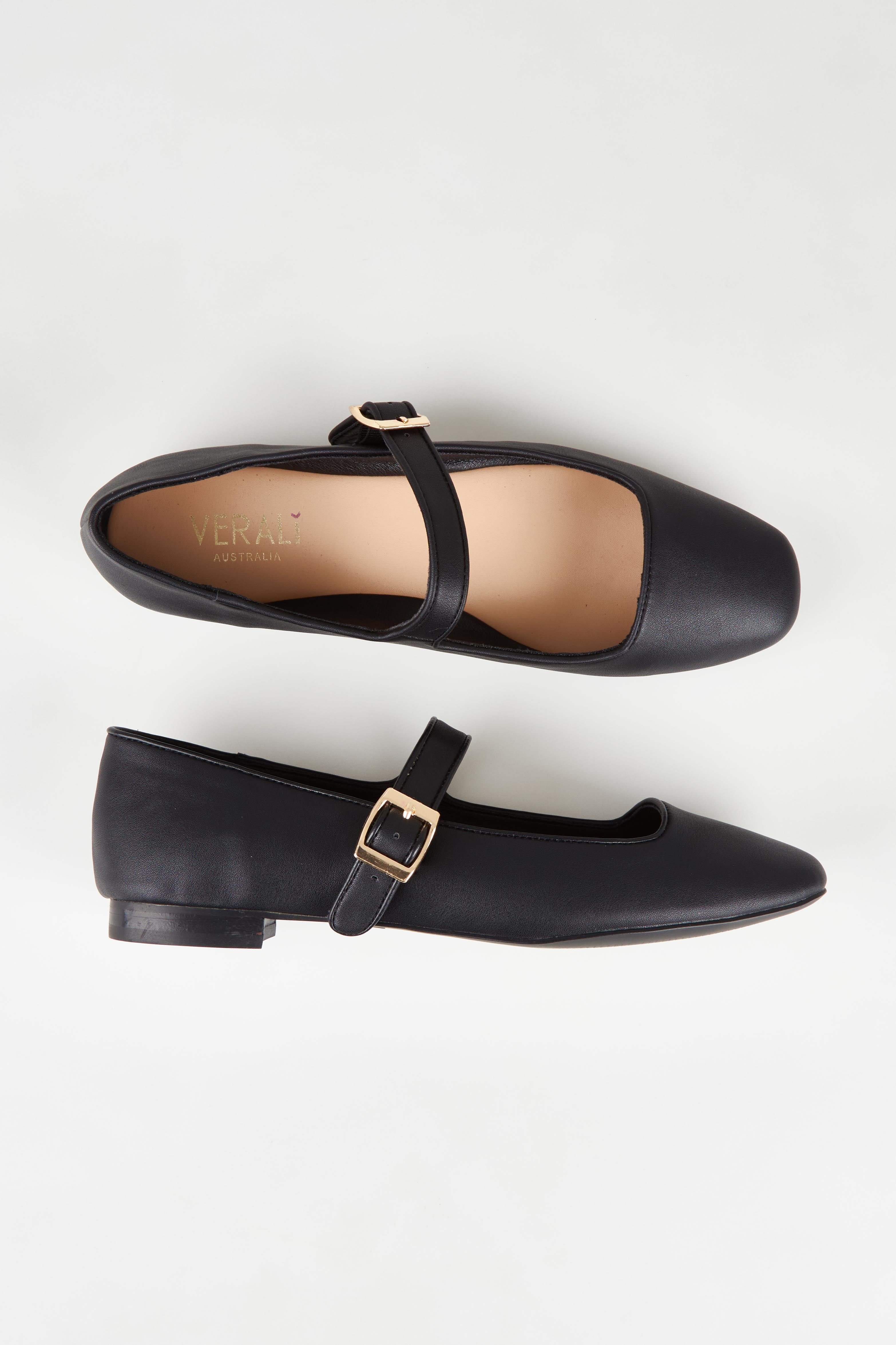 A model wearing size 37 of the Eden Mary Jane Flat in colour Black (Black), from the front, showing the whole outfit