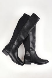 A model wearing size 37 of the Gala Knee Boot in colour Black (Black), from the front, showing the whole outfit