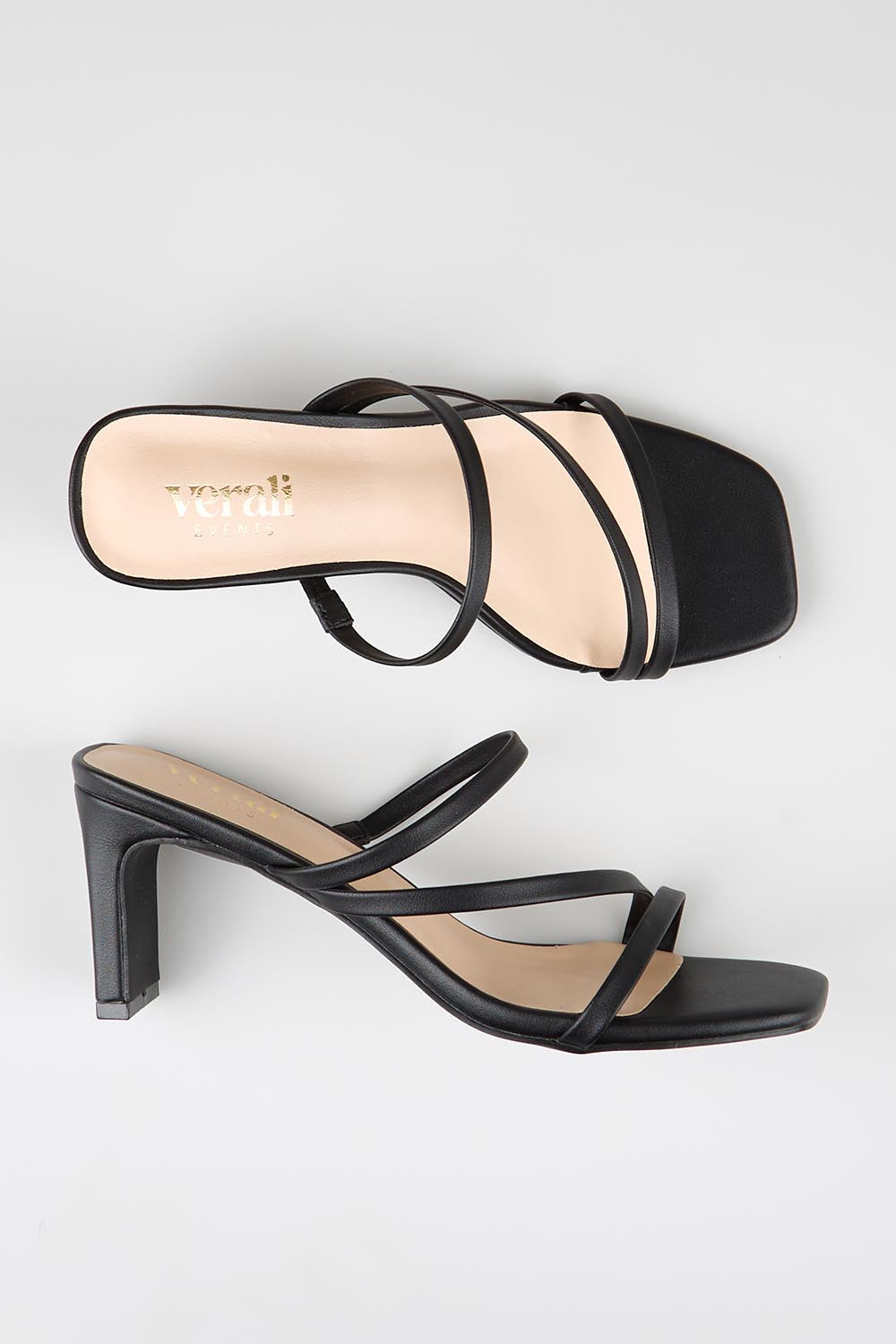 Model Genericm wearing size sample of the Ginny Heel - Black in colour Black, from an angle