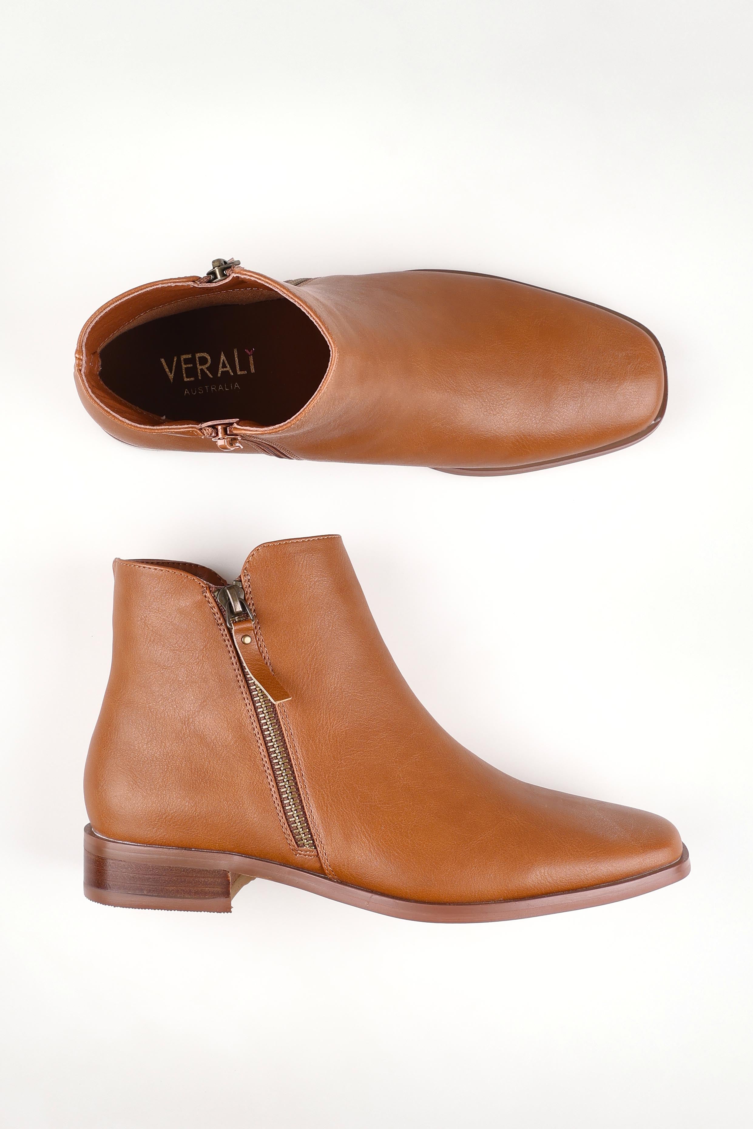 A model wearing size 37 of the Hawk Double Zip Ankle Boot in colour Tan, from the front, showing the whole outfit