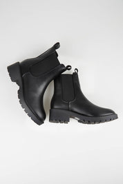 A model wearing size 37 of the Jalapeno Ankle Boot in colour Black (Black), from the front, showing the whole outfit