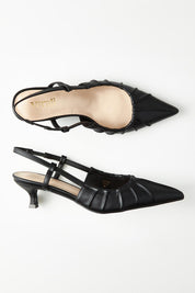 A model wearing size 37 of the Lucius Kitten Heel in colour Black (Black), from the front, showing the whole outfit