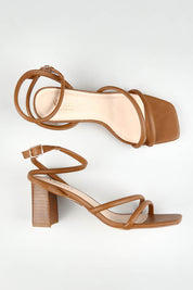 A model wearing size 37 of the Nadia Heel in colour Tan, from the front, showing the whole outfit